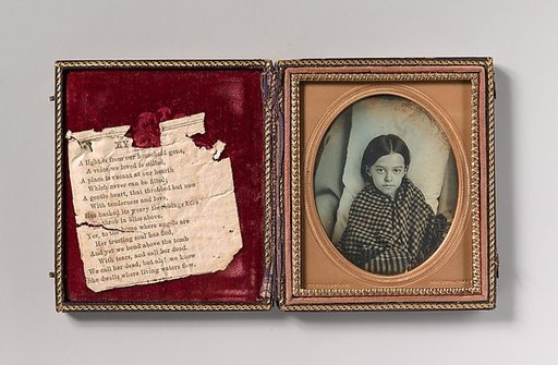 [Young Girl Wearing Gingham Shawl, Resting on Pillow]