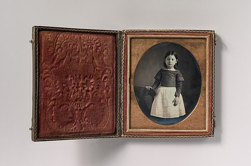 [Young Girl Wearing Waist Apron, Resting Hand on Chair]