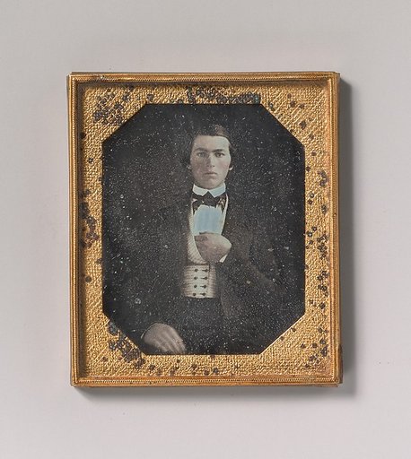 [Young Man with Hand Tucked in Vest]