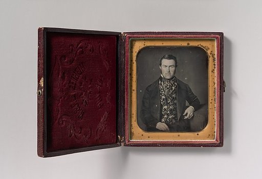[Seated Man in Floral Vest]