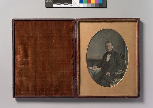 [Seated Man Pointing to a Passage in an Open Book]