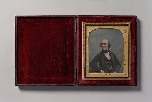 [Middle-aged Man with Glasses Holding Pocket Watch]