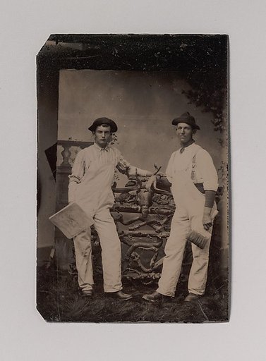 [Two Plasterers in Overalls Leaning on a Rustic Fence]