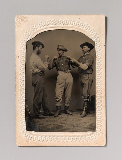 [Two Men in Boxing Stance, a Third Man Adjusting One Man's Form]