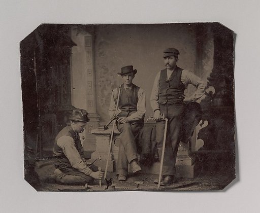 [Three Plumbers with Pipes and Tools]