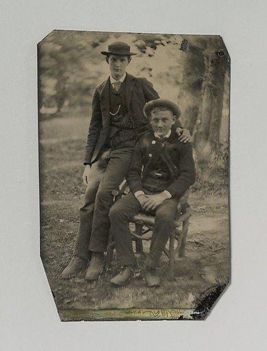 [Two Young Men Outdoors, One Seated, the Other on the Arm of the Chair]