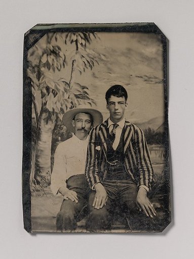 [Young Man in a Striped Jacket, Sitting on the Lap of Another Man in Front of Painted Outdoor Backdrop]
