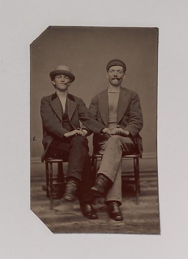 [Two Seated Young Men Holding Hands]
