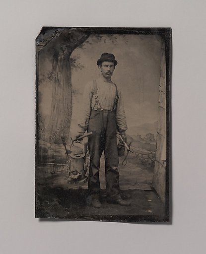 [Tinsmith in Front of Painted Outdoor Backdrop]