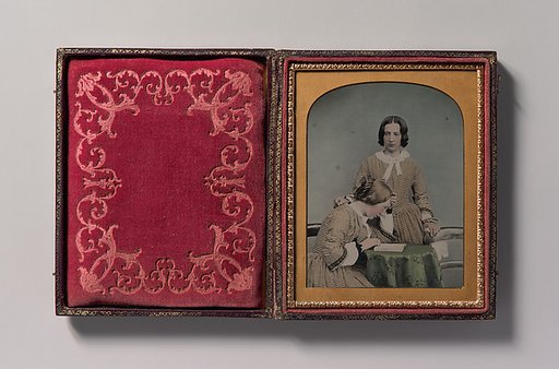 [Two Women Wearing Striped Dresses, One Standing, the Other Seated]