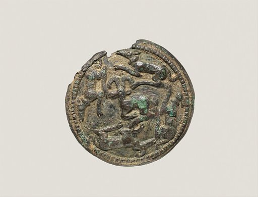Disc with running dogs surrounding a mountain goat