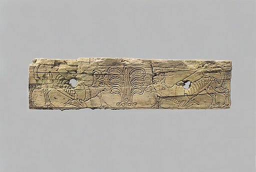 Incised furniture plaque with two ibexes flanking a stylized palmette tree