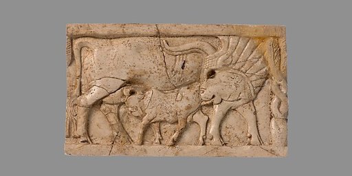 Furniture plaque carved in relief with a cow suckling a calf
