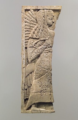 Furniture plaque carved in relief with standing woman