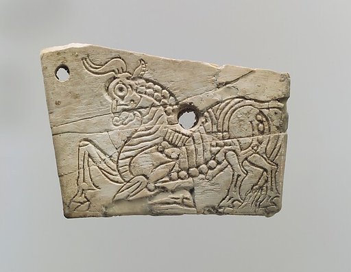 Incised furniture plaque with a kneeling bull