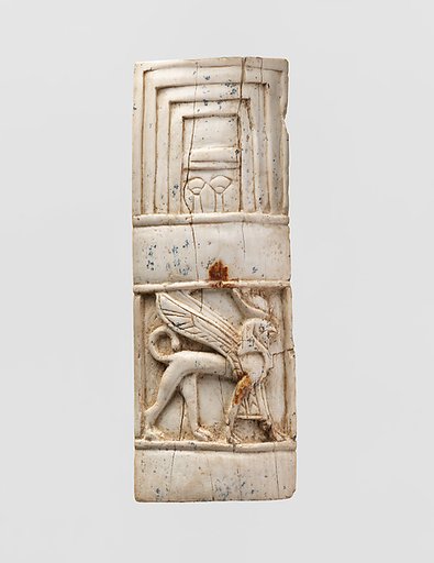 Furniture plaque carved in relief with window and sphinx