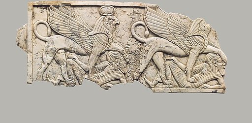 Furniture plaque carved in relief with two falcon-headed sphinxes trampling captives