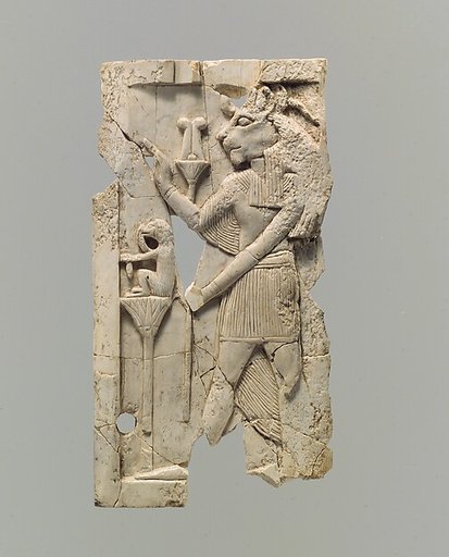 Furniture plaque carved in relief with lion-headed figure