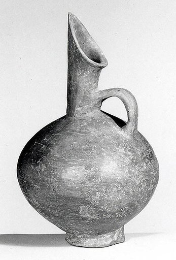 Spouted jug with a mottled surface