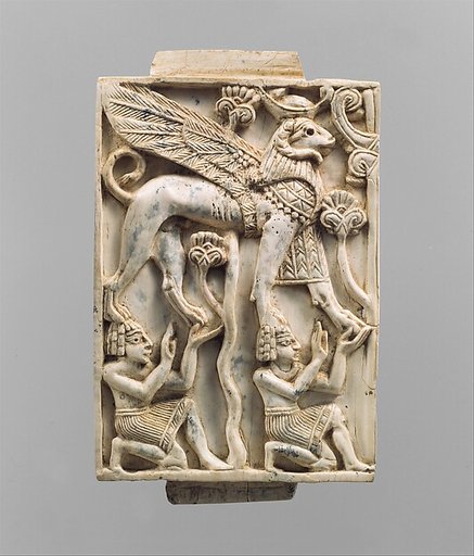 Furniture plaque carved in relief with a striding, ram-headed sphinx supported by two kneeling figures