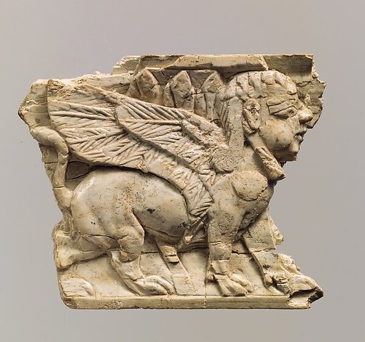 Furniture plaque carved in relief with sphinx