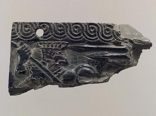 Furniture plaque carved in relief with warrior