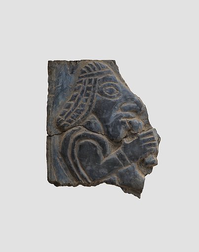 Furniture plaque carved in relief with man holding vessel to his mouth