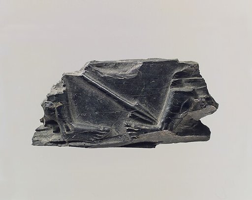 Furniture plaque carved in relief with spear