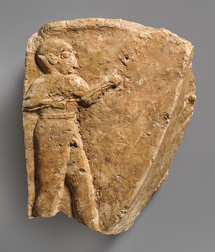 Fragment of a trough with a nude male figure in relief