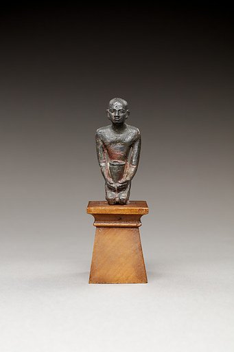 Pediusir kneeling, holding a jar