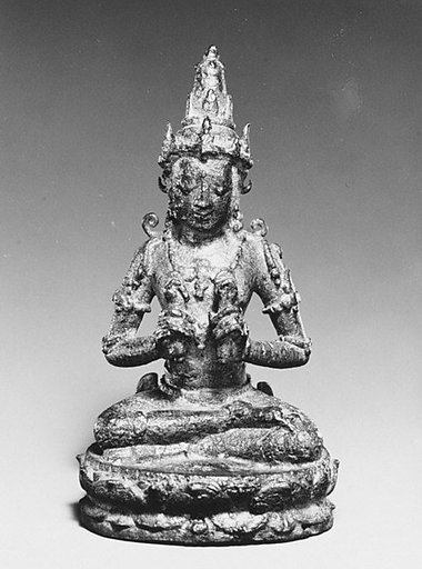Seated Male Deity Holding Two Ritual Objects