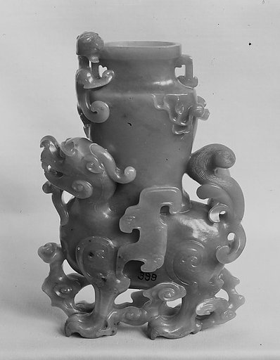 Fantastic creature supporting a vase
