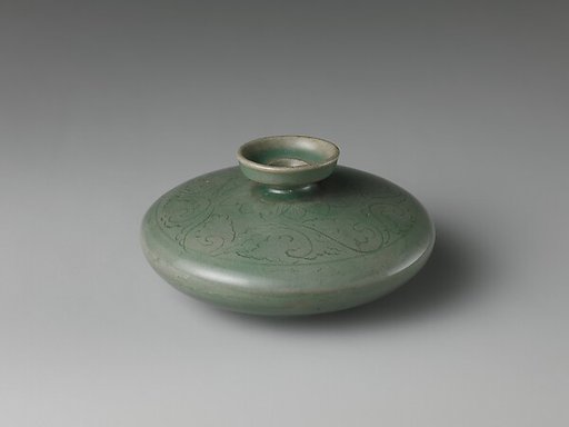 Oil bottle decorated with floral scrolls and lotus petals