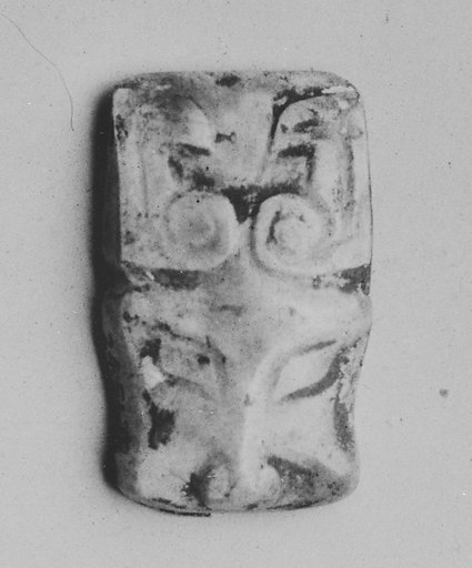 Plaque in the shape of an animal head