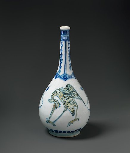 Bottle Depicting Storks in Blue and Yellow on a White Background