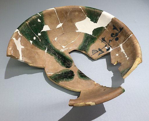 Fragments of a Bowl with Green Splashes and Blue Inscription