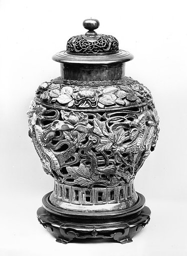 Jar with dragon amid flowers