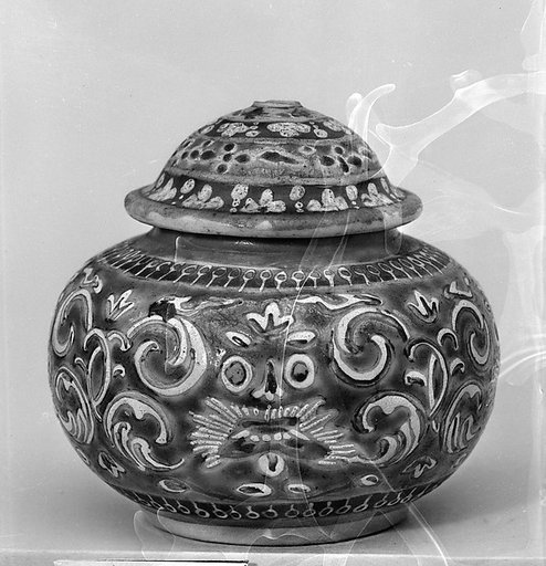 Covered jar with animal masks