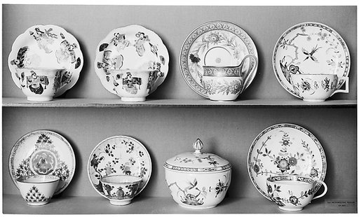 Cup and saucer with flowers and vases
