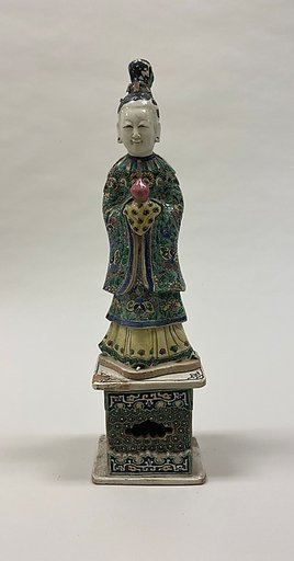 Figure of a fairy holding a peach