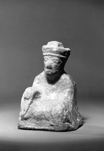 Miniature figure of a seated man