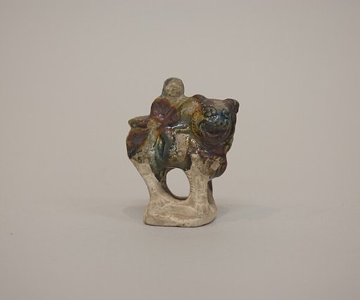 Minature figure of a lion and rider