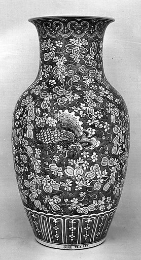 Vase with butterflies amid melon vines