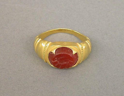 Ring with Ridged Segments and Inset Red Stone