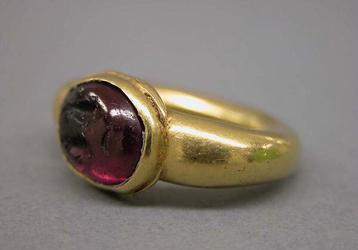 Ring with Dark Red Inset Oval-Shaped Stone