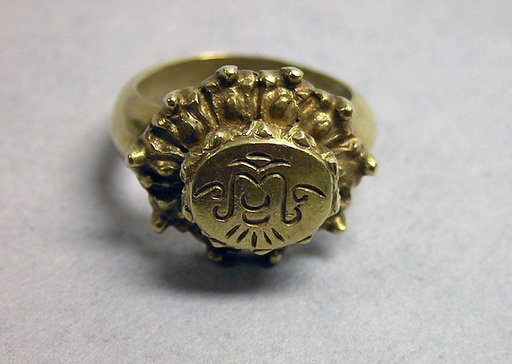Ring with Oval Bezel and Foliate Border with "Sri"