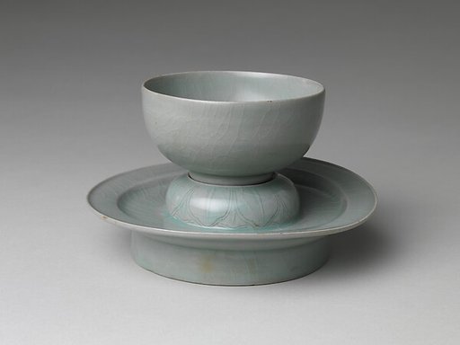 Cup and stand decorated with lotus seeds and petals