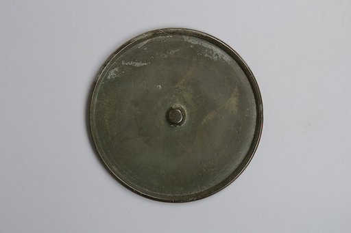 Mirror with incised Buddhist triad
