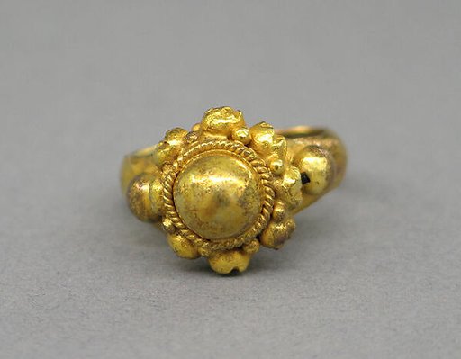 Ring with Large Central Boss Flanked by Series of Same