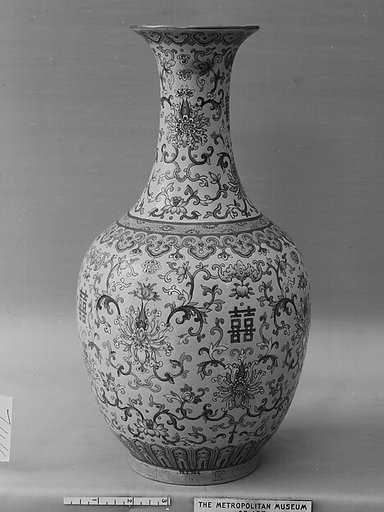 Vase decorated with bats and peaches amid scrolling floral vines